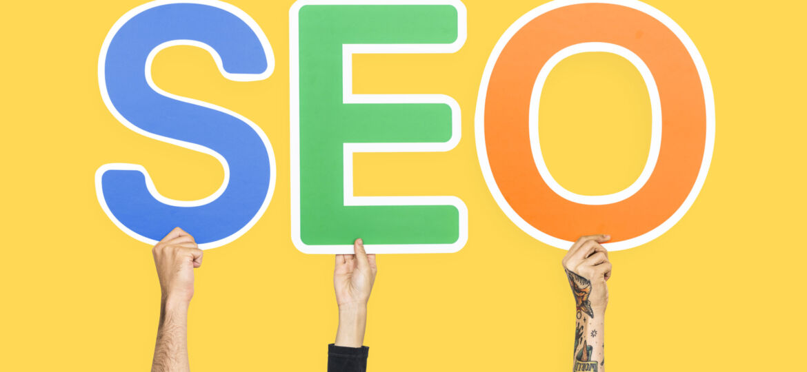 Hands holding up colorful letters forming the abbreviation  SEO (Demo)