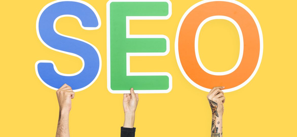 Hands holding up colorful letters forming the abbreviation  SEO (Demo)